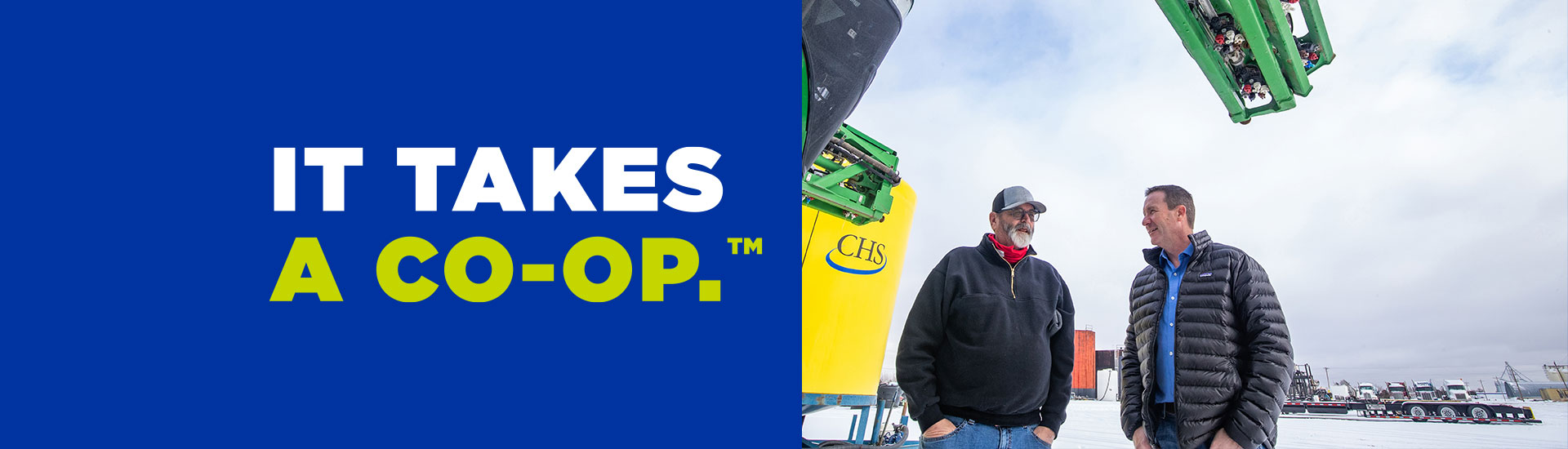 Two men with IT TAKES A CO-OP on the left