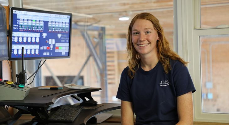 A woman sitting in a fertilizer shed.