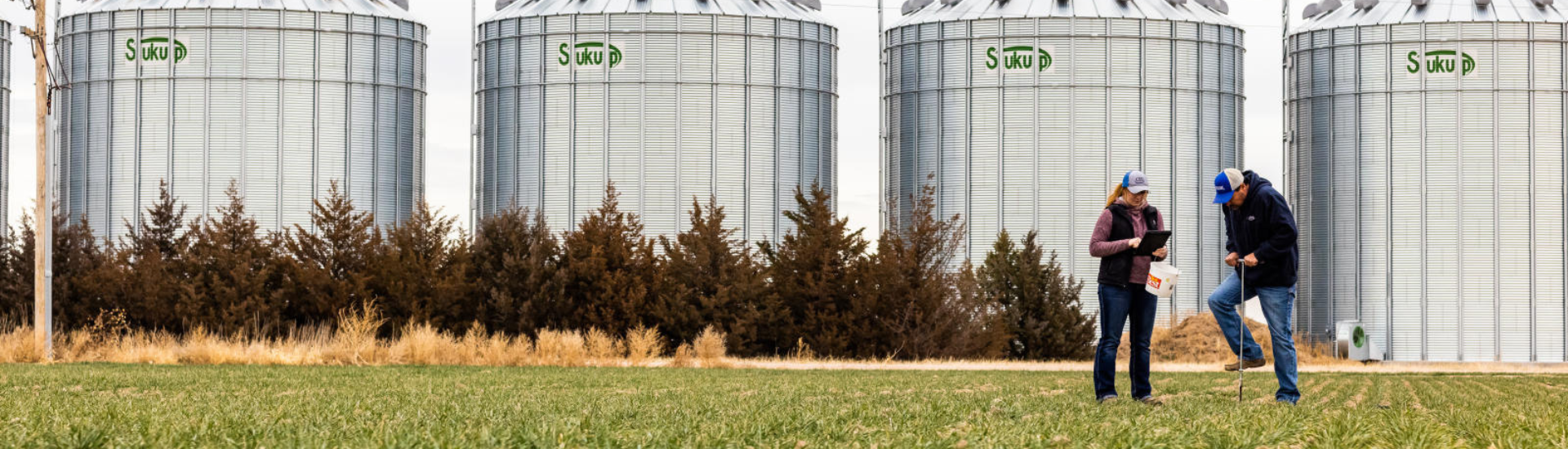 Two people standing in a field