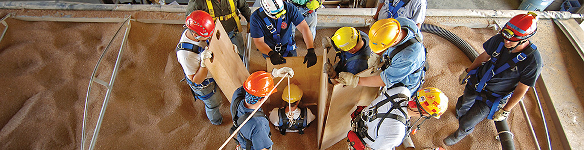 Firefighters performing a grain bin safety exercise