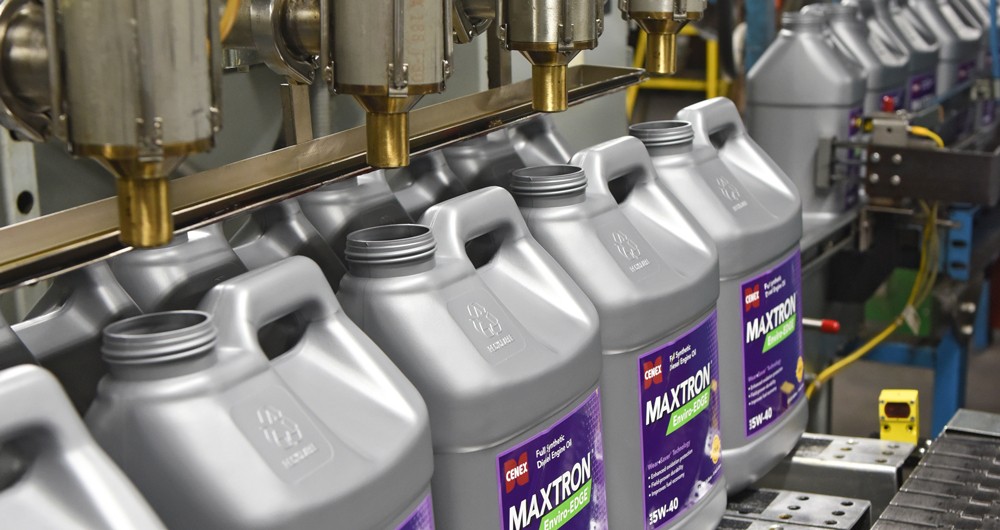 Maxtron product jugs being filled on a production line