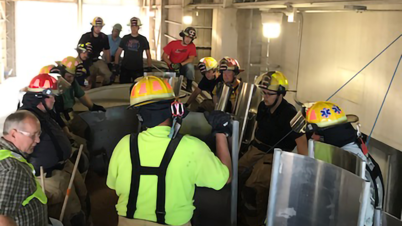 Firefighters going through a grain bin safety exercise